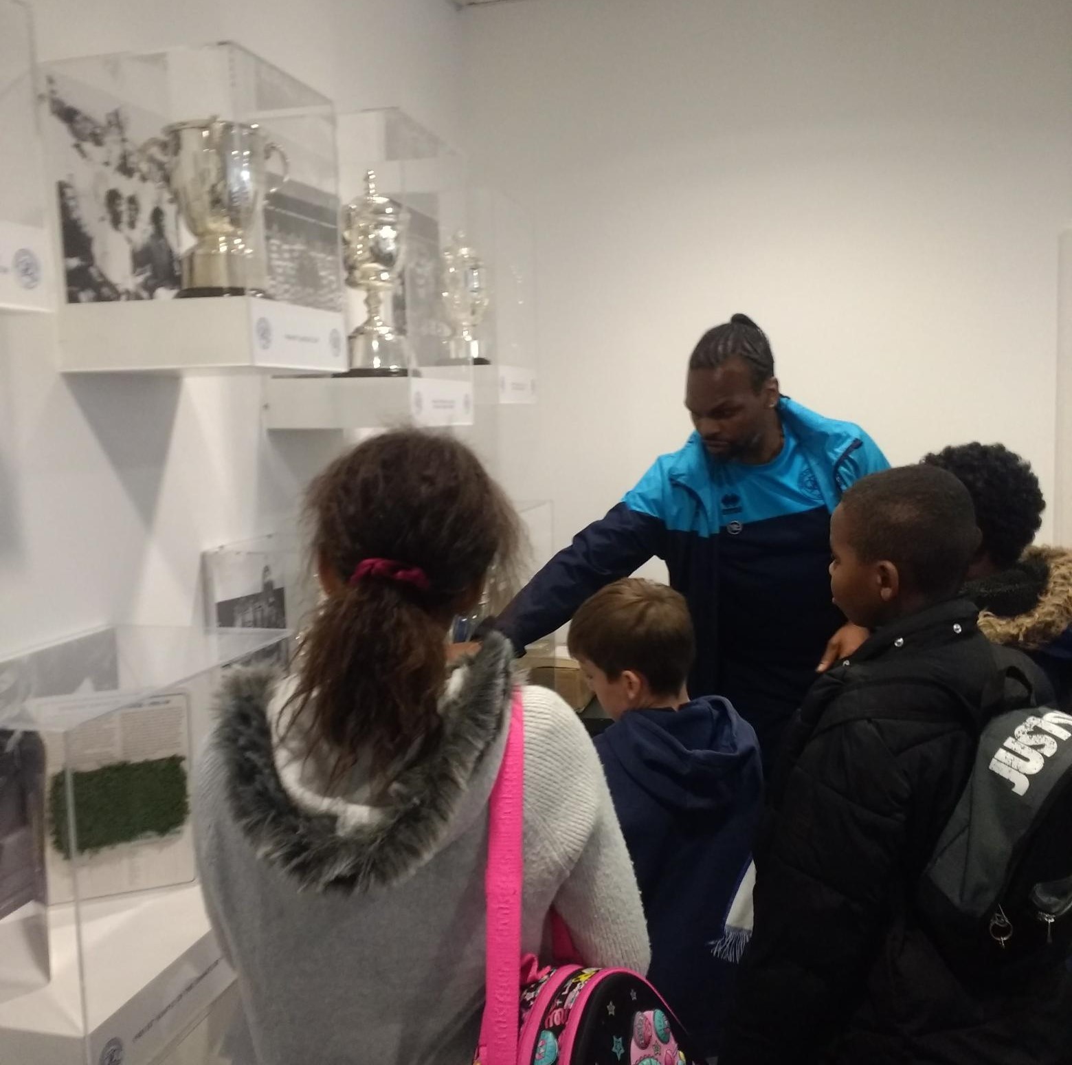 The children look at QPR trophies 