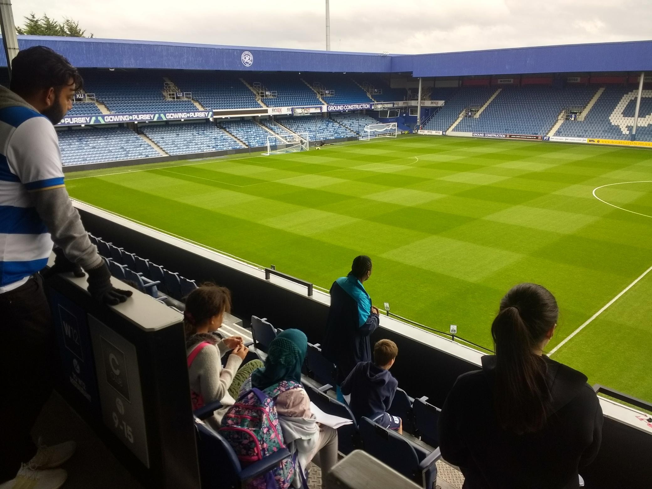 The children view the football pitch from the stadium