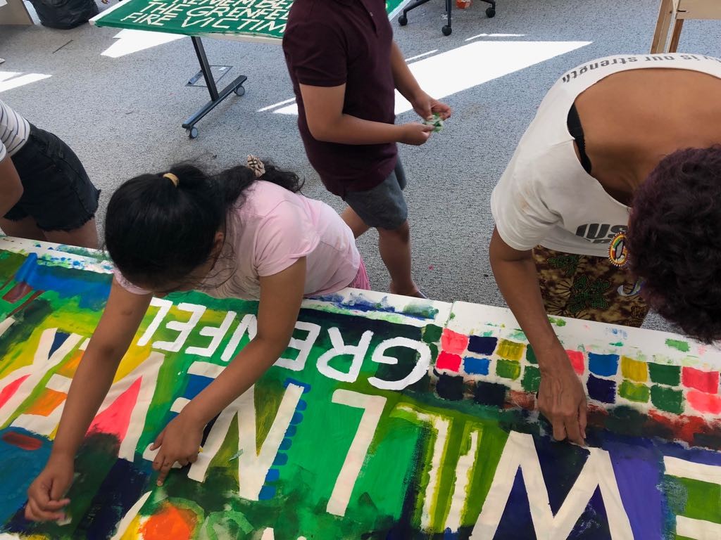 young children working on a banner